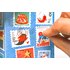 Hand opening a small door of the spice advent calendar with festive stamp motifs