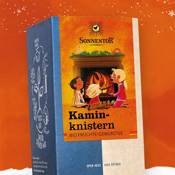 Packaging of Sonnentor Kaminknistern tea, organic fruit and spice tea with winter fireplace illustration