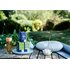 In the picture you can see three Happiness Is tea packs in nature. Next to them is a bottle of tea, a yoga mat and a pillow.
