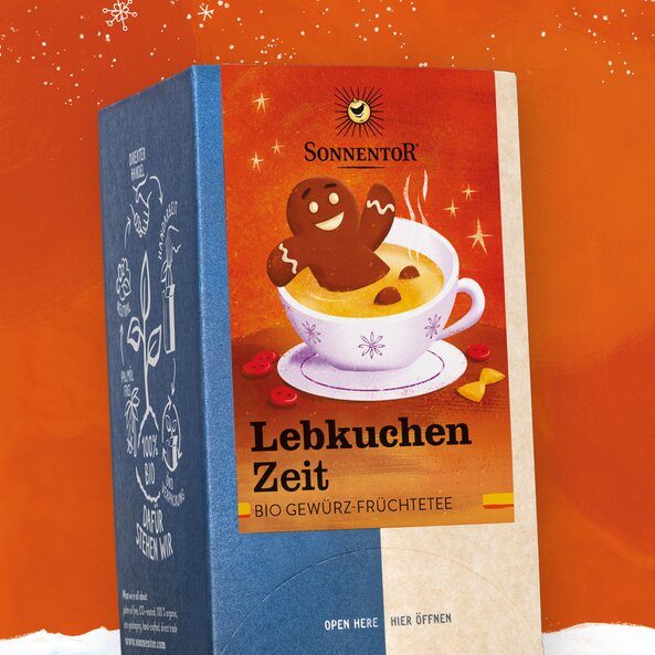 Gingerbread Time organic spiced fruit tea by Sonnentor in festive packaging with gingerbread figure in a cup
